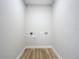 Small laundry room with linoleum floor and space for washer and dryer at 645 King St, Eustis, FL 32726