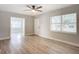 Bright living room with wood-look floors and access to sunroom at 645 King St, Eustis, FL 32726