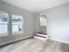 Spacious living room with wood-look floors and access to sunroom at 645 King St, Eustis, FL 32726