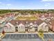 Aerial view of townhouses with brown roofs and parking at 7591 Sunny Dreams Ln, Kissimmee, FL 34747