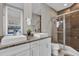 Bathroom with double vanity, shower, and granite countertop at 7591 Sunny Dreams Ln, Kissimmee, FL 34747