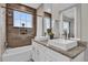 Bathroom with double vanity, tub, and shower at 7591 Sunny Dreams Ln, Kissimmee, FL 34747