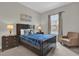 Guest bedroom with a double bed and an armchair at 7591 Sunny Dreams Ln, Kissimmee, FL 34747