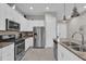 Modern kitchen with stainless steel appliances and granite countertops at 7591 Sunny Dreams Ln, Kissimmee, FL 34747