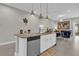 Modern kitchen with island, stainless steel appliances, and granite countertops at 7591 Sunny Dreams Ln, Kissimmee, FL 34747