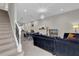 Carpeted staircase with metal railing in open concept home at 7591 Sunny Dreams Ln, Kissimmee, FL 34747