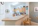 Kitchen with light wood cabinets and breakfast bar at 8407 Crystal Cove Cv, Kissimmee, FL 34747