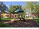 playground with playset and slides, located in a community with residential buildings at 8407 Crystal Cove Cv, Kissimmee, FL 34747