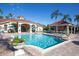 Community swimming pool with lounge chairs and a shaded bar area at 8407 Crystal Cove Cv, Kissimmee, FL 34747