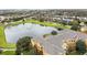 Aerial view of community with lake and building at 8660 Buccilli Dr # 305, Orlando, FL 32829