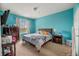 Serene bedroom with teal walls and a king-size bed at 8660 Buccilli Dr # 305, Orlando, FL 32829