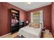 Cozy bedroom with double bed, bookcase, and window at 8660 Buccilli Dr # 305, Orlando, FL 32829