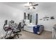 Bedroom features a ceiling fan, a bed with a blue blanket and neutral paint at 900 Windlass Ct, Kissimmee, FL 34746