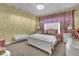 Charming bedroom featuring a white bed frame, unique decor, and carpet flooring at 900 Windlass Ct, Kissimmee, FL 34746
