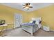Bright bedroom has a ceiling fan, carpet floors, and a door leading to the backyard at 900 Windlass Ct, Kissimmee, FL 34746