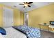 Bright bedroom with yellow walls, carpet floors, and a ceiling fan at 900 Windlass Ct, Kissimmee, FL 34746