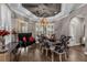 Formal dining room with elegant decor, including stylish chairs, chandelier lighting, and window shutters at 900 Windlass Ct, Kissimmee, FL 34746