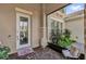 Charming covered porch with decorative glass front door and seating area at 900 Windlass Ct, Kissimmee, FL 34746