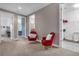 Hallway with red accent chairs offers access to bedrooms, bathroom and laundry room at 900 Windlass Ct, Kissimmee, FL 34746