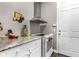 A modern kitchen with white cabinets, granite countertops, and stainless steel appliances at 900 Windlass Ct, Kissimmee, FL 34746