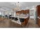Open-concept kitchen with dark wood cabinets, a large island with seating, and modern stainless steel appliances at 900 Windlass Ct, Kissimmee, FL 34746