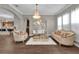 Elegant living room with a chandelier, stylish seating, and open access to the kitchen at 900 Windlass Ct, Kissimmee, FL 34746