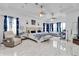 Spacious bedroom with high ceilings, tile floors, sitting area, and large windows with custom draperies at 900 Windlass Ct, Kissimmee, FL 34746
