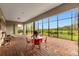 Covered patio with brick flooring, dining table, chairs, and a view of nature at 900 Windlass Ct, Kissimmee, FL 34746