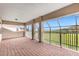 Wide angle view of a covered patio with brick flooring and a view of nature at 900 Windlass Ct, Kissimmee, FL 34746