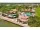Aerial view of the community pool, playground, and lakeside homes in the neighborhood at 900 Windlass Ct, Kissimmee, FL 34746