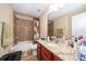 Clean bathroom with granite vanity and tub shower at 11322 Bronson Rd, Clermont, FL 34711