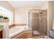 Relaxing bathroom with soaking tub and glass shower at 11322 Bronson Rd, Clermont, FL 34711