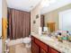 Clean bathroom with shower/tub combo and granite vanity at 11322 Bronson Rd, Clermont, FL 34711