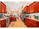 Well-equipped kitchen with wood cabinets and granite counters at 11322 Bronson Rd, Clermont, FL 34711