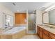 Bathroom with soaking tub, walk-in shower, and double vanity at 12544 Floridays Resort Dr, Orlando, FL 32821