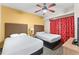 Bedroom with two double beds and red curtains at 12544 Floridays Resort Dr, Orlando, FL 32821