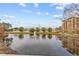 Tranquil lake view with fountain and residential buildings at 12544 Floridays Resort Dr, Orlando, FL 32821