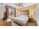 King sized bed, ceiling fan, and large TV in main bedroom at 12544 Floridays Resort Dr, Orlando, FL 32821
