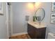 Modern bathroom with dark vanity, round mirror, and tasteful decor at 1933 Island Walk Dr, Orlando, FL 32824