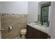 Updated bathroom with granite vanity, tiled shower, and modern fixtures at 1933 Island Walk Dr, Orlando, FL 32824