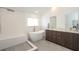 Spa-like bathroom with freestanding tub, walk-in shower, and dual sinks at 1933 Island Walk Dr, Orlando, FL 32824