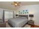 Main bedroom with gray bedding and ceiling fan at 1933 Island Walk Dr, Orlando, FL 32824