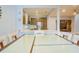 Open concept dining area with glass top table and kitchen view at 1933 Island Walk Dr, Orlando, FL 32824