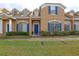 Front view of tan two-story house with blue shutters at 1933 Island Walk Dr, Orlando, FL 32824