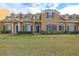 Tan two-story house with blue shutters and a manicured lawn at 1933 Island Walk Dr, Orlando, FL 32824