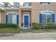 Blue door entryway with stone accents and landscaping at 1933 Island Walk Dr, Orlando, FL 32824