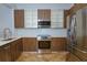 Modern kitchen with stainless steel appliances and light wood cabinets at 1933 Island Walk Dr, Orlando, FL 32824
