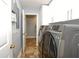 Bright laundry room features modern washer and dryer, tile flooring and ample cabinetry at 1933 Island Walk Dr, Orlando, FL 32824