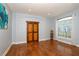Bright living room with hardwood floors, large window, and barn door at 1933 Island Walk Dr, Orlando, FL 32824