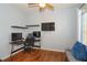 Home office with wood floors, corner desk, and flat screen TV at 1933 Island Walk Dr, Orlando, FL 32824
